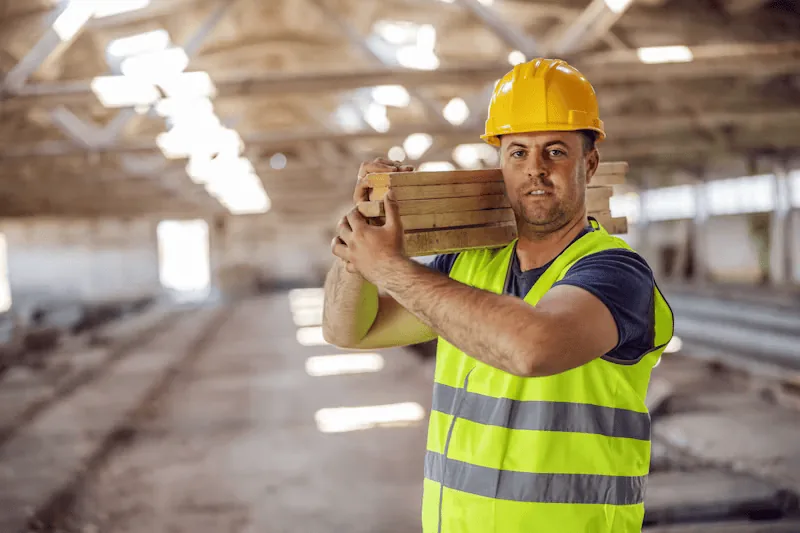 Construction worker lifts heavy objects, increasing the risk of herniated discs.