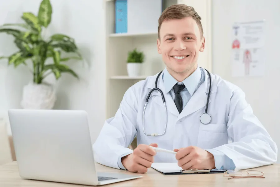 A doctor smiling at the camera.
