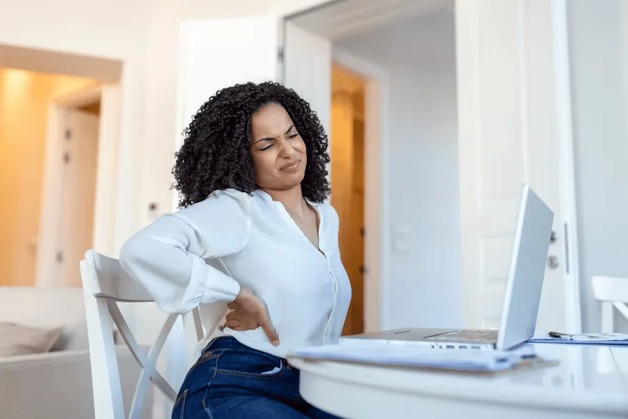 A woman has back pain.