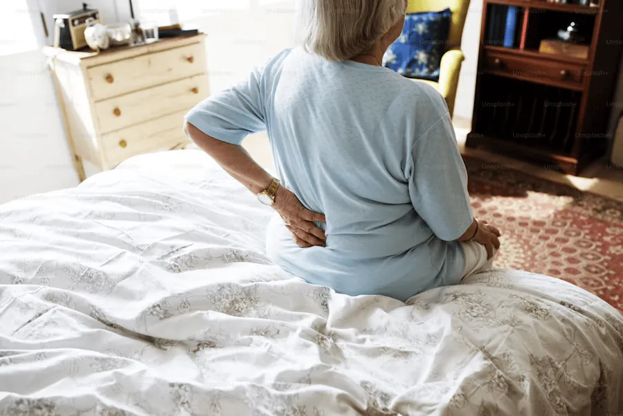 Elderly woman in pain and struggling to stand up because she suffers from rheumatism.