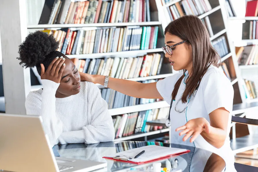 A woman is treated by a doctor for her tension headaches.